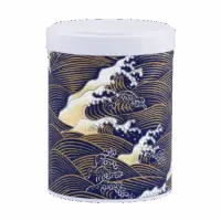 Photo de la boîte à thé empilable - Vague : papier washi, écume de vague sur fond bleu et doré style japonais. Boîte ronde, couvercle noir.