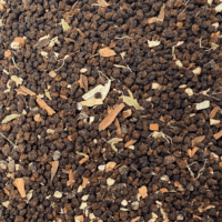 Kadak Chai BIO : Photo du thé vu de haut. Thé noir en petites billes, toutes les épices sont apparentes en morceaux assez grossiers (cannelle, clou de girofle, gingembre, cardamome et poivre).